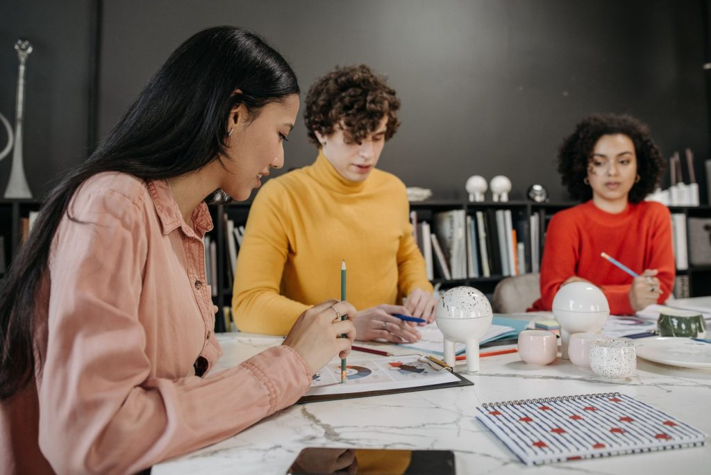 Diverse team planning and strategizing together in a modern office setting.